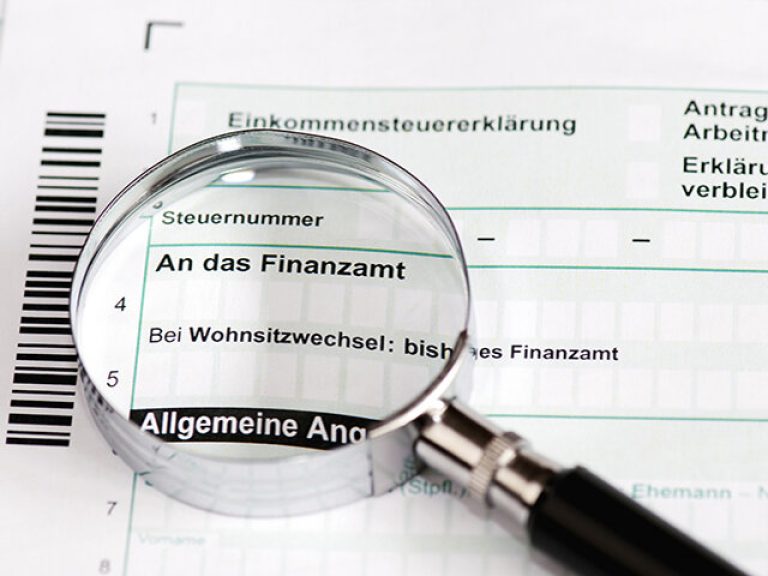 Close up of a german tax form with magnifier - Einkommenssteuererklaerung