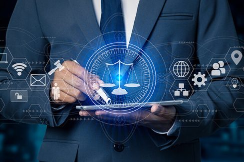 Justice and law concept. Lawyer businessman holding digital tablet and law innovation network icons. blurred background.