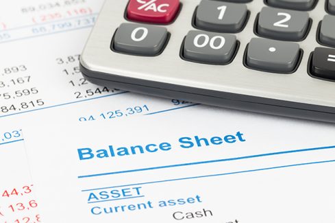 Balance sheet report with calculator; document is mock-up